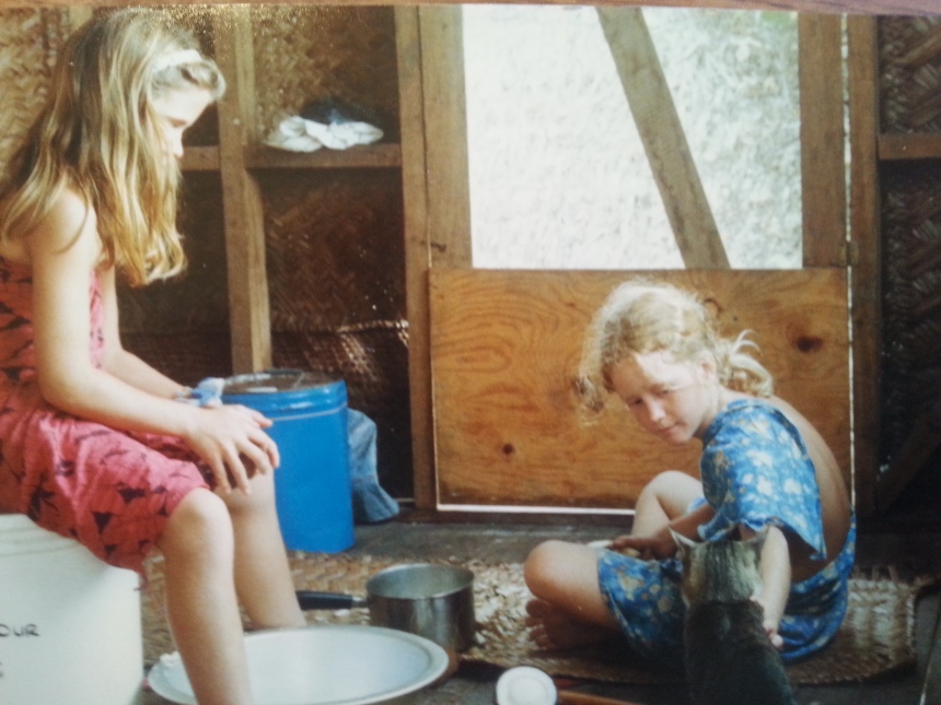 My sister and I on the veranda grating coconut (and feeding the cat).